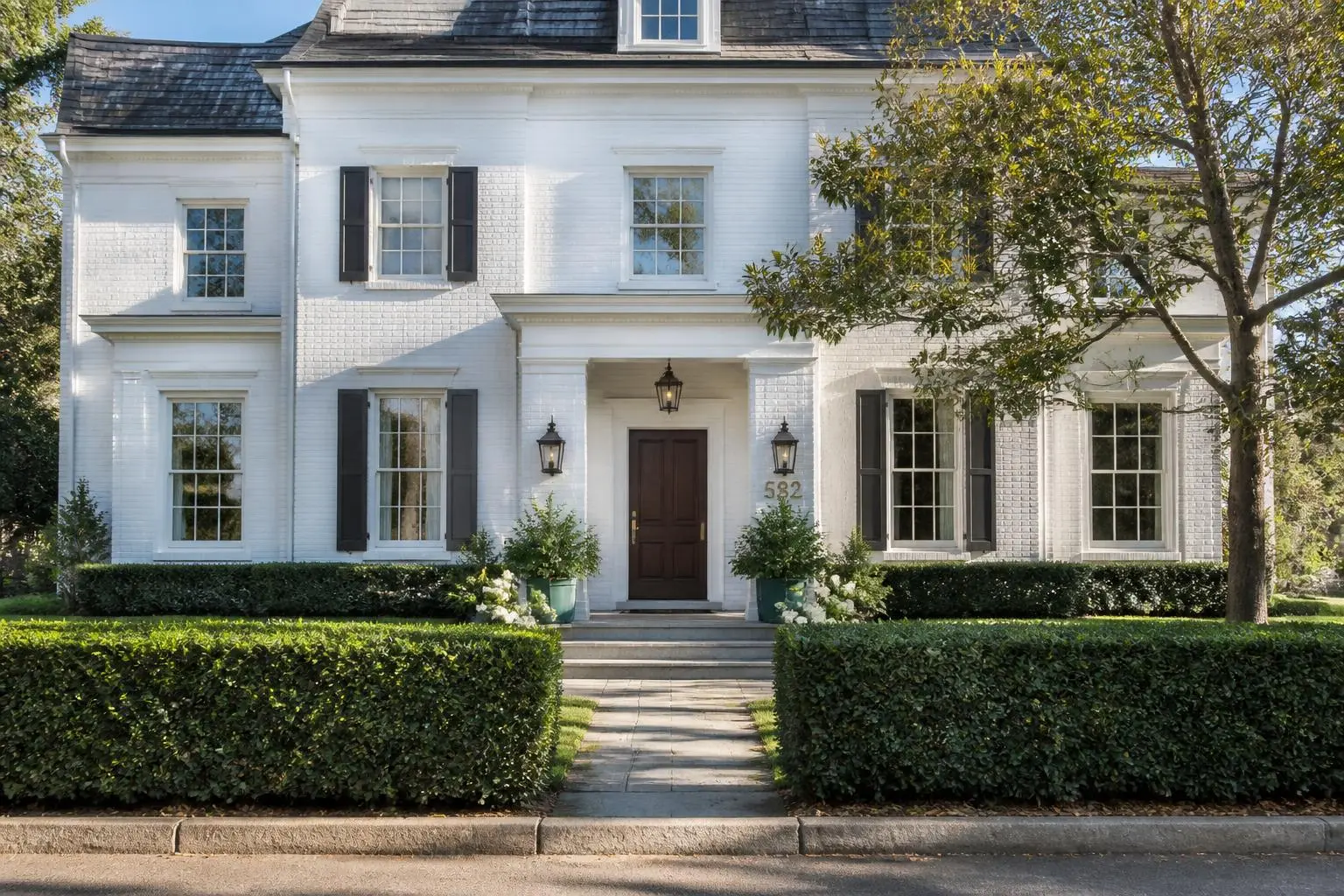 A stately brick estate home beneath mature trees in Eastover, Charlotte